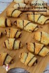Chocolate rugelach on a wooden tray.
