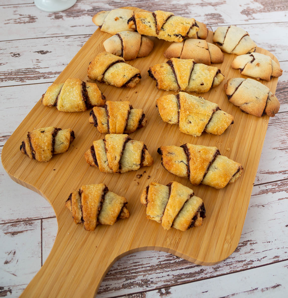Chocolate rugelach on a wooden tray.