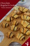Chocolate rugelach on a wooden tray.