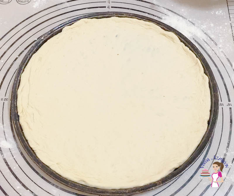 Transfer the pizza dough to a pizza baking tray