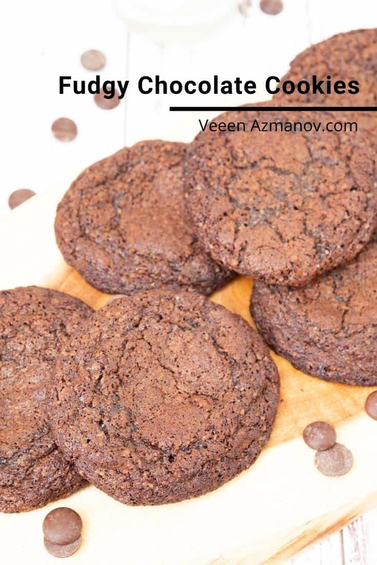 A stack of fudge chocolate cookies on a wooden tray.