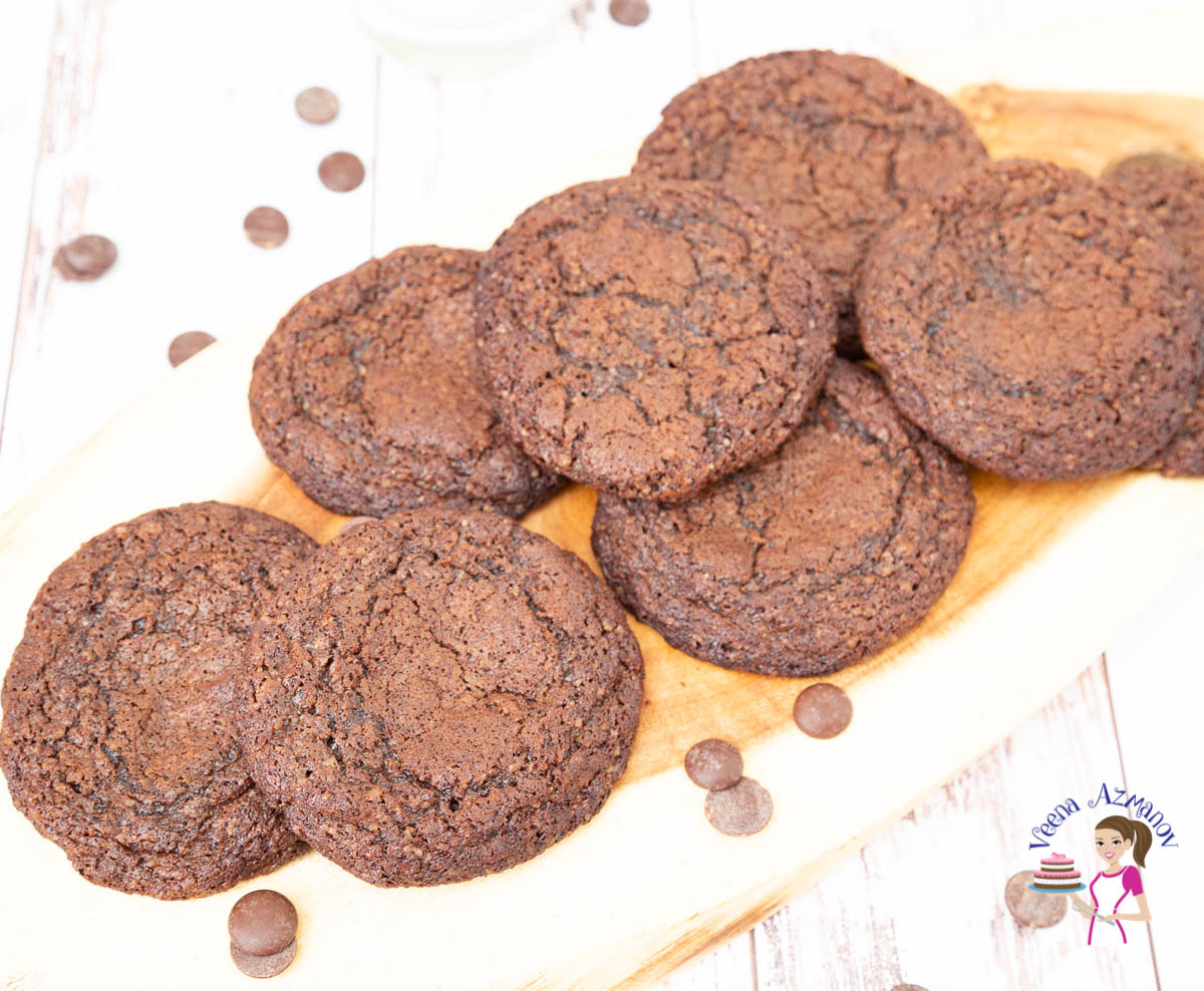A stack of fudge chocolate cookies on a wooden tray.