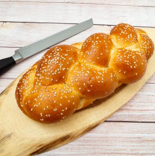 Challah bread on a wooden board.