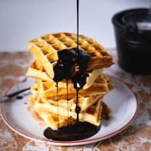 Waffles with pouring chocolate syrup.