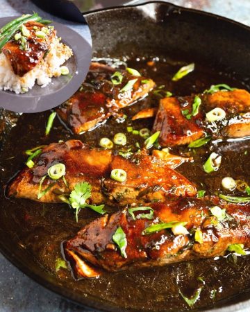 A skillet with salmon in balsamic glaze.