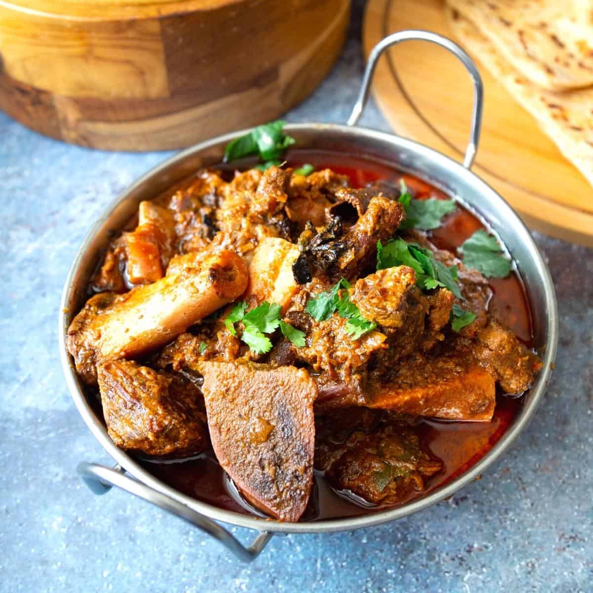 An Indian serving dish with goat curry.