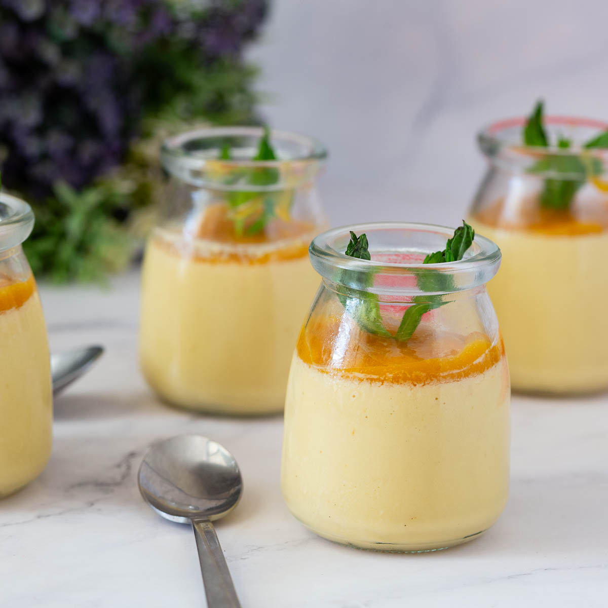 Mango panna cotta jars on the table.