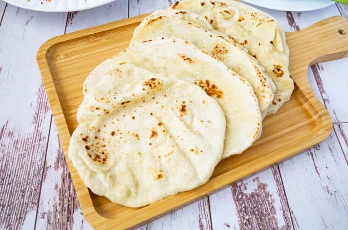 A few flatbread on a wooden tray for display