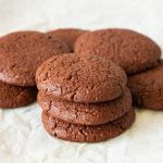 Stack of fudge chocolate cookies on the table.