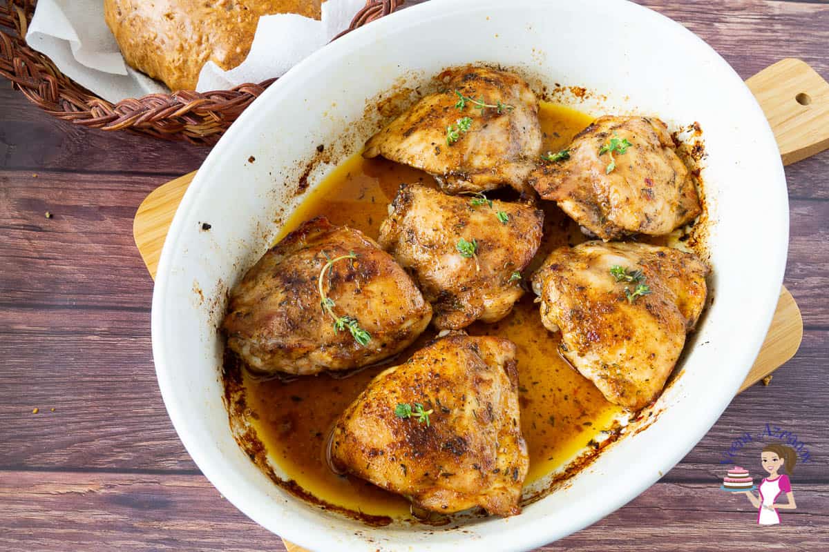 A baking dish with baked chicken thighs.