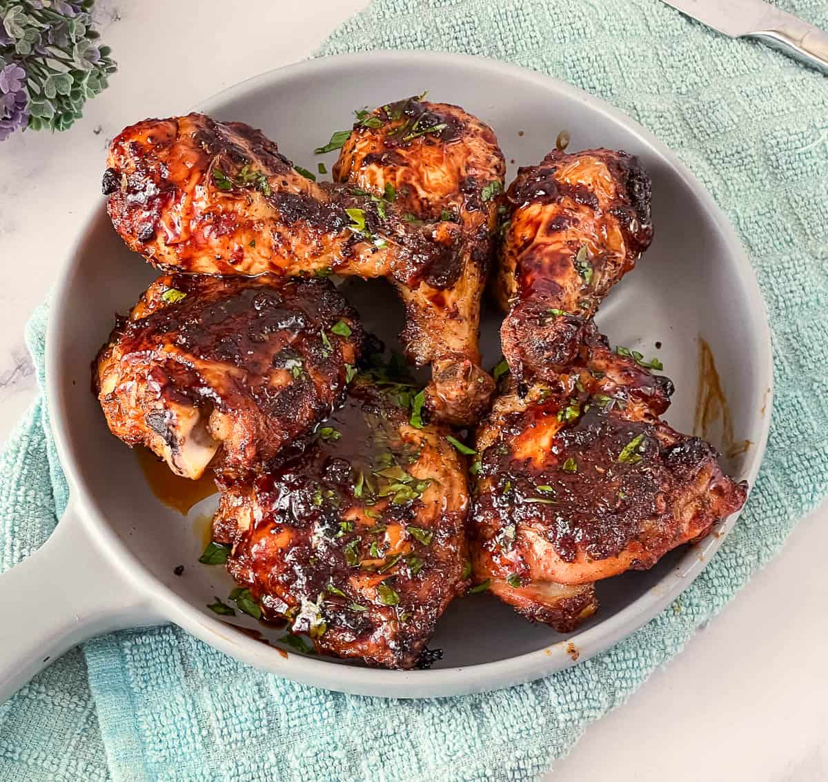 A plate with baked cajun chicken.