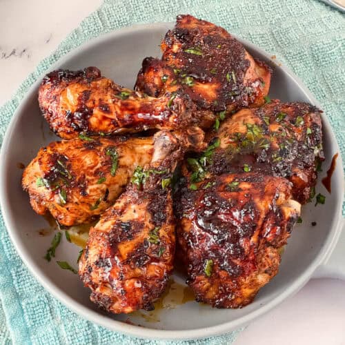A serving platter with cajun baked chicken.