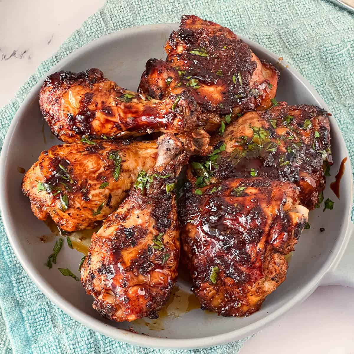 A serving platter with cajun baked chicken.