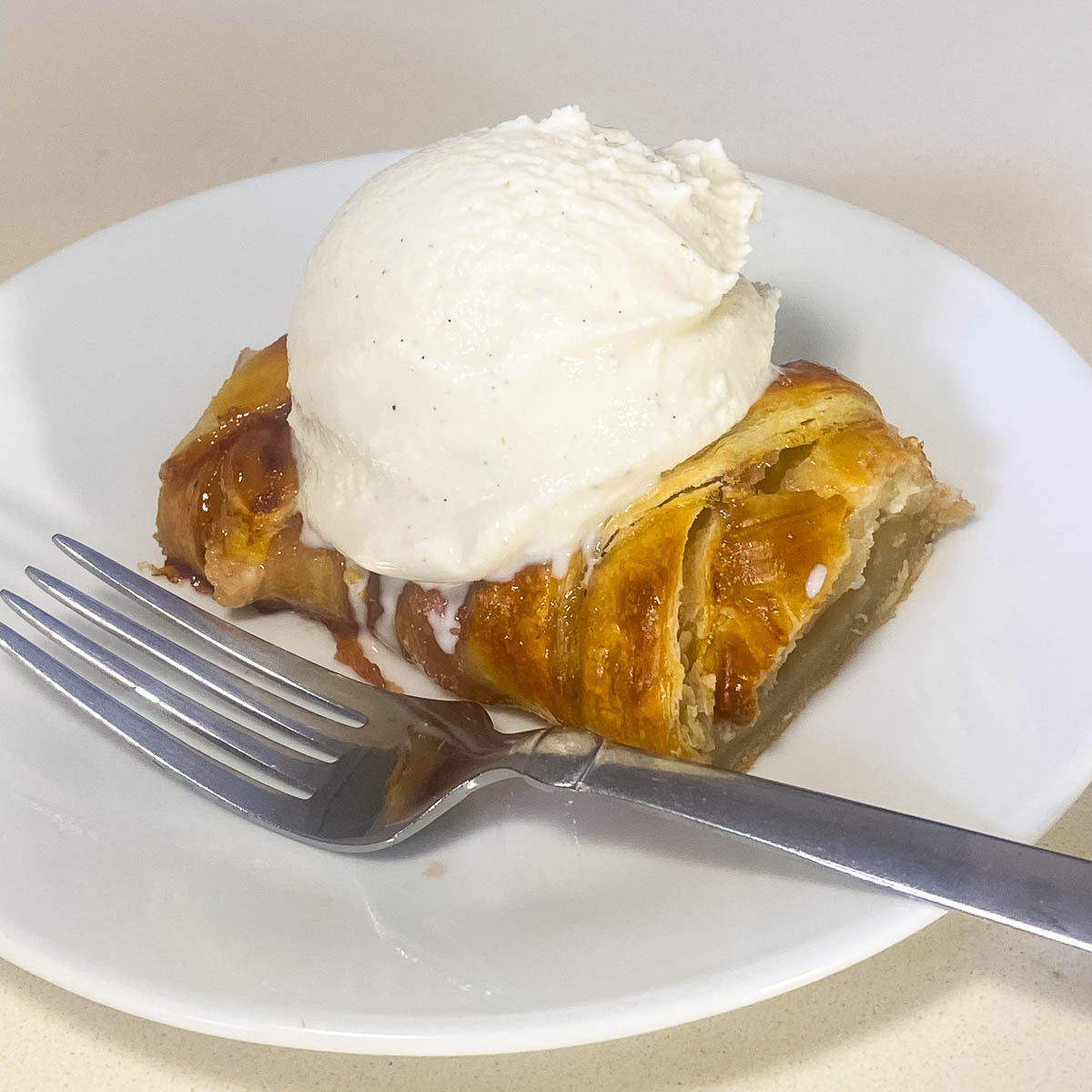 Braided pastry with strawberry and ice cream.