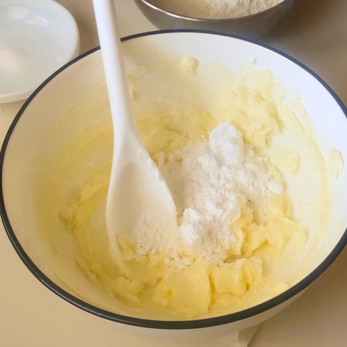 Cream butter and powdered sugar in a bowl.