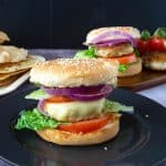 Ground chicken burgers on a black plate.
