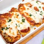 A baking dish with chicken parmesan recipe.