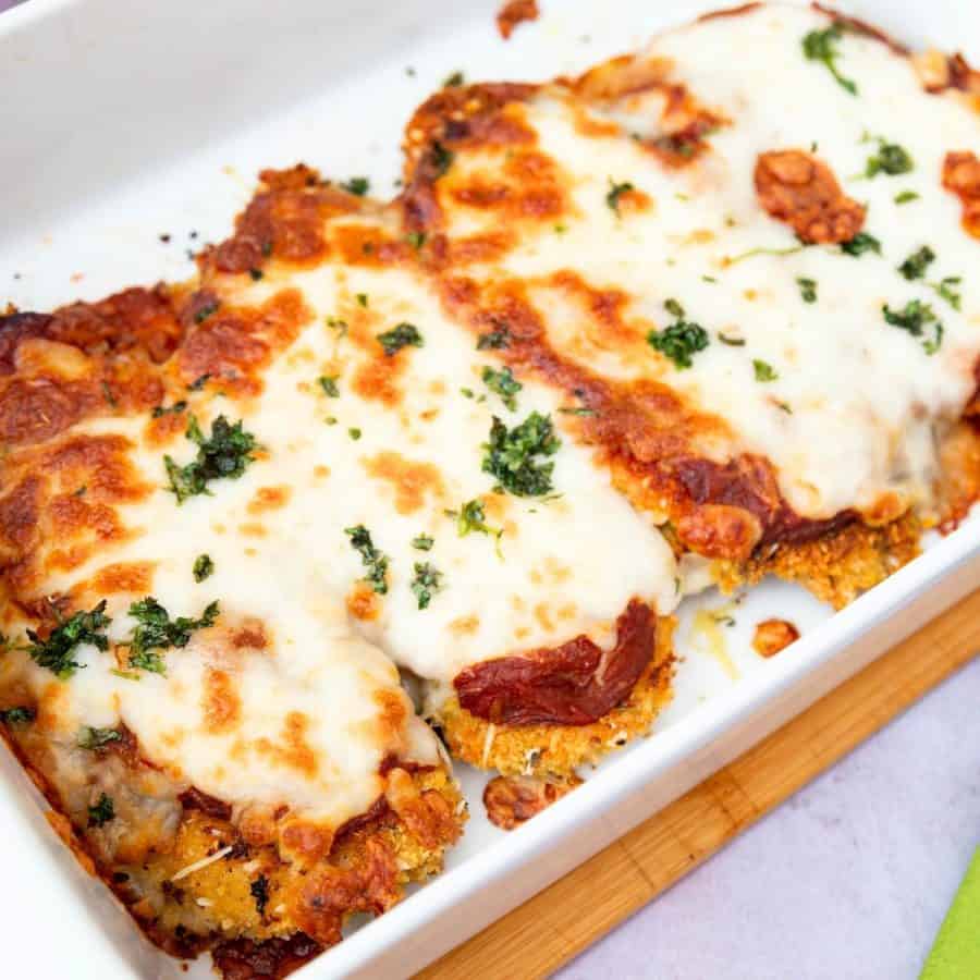 A baking dish with chicken parmesan recipe.