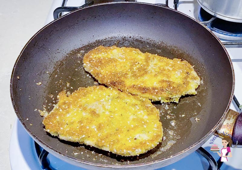 Fry the breaded chicken on a frying pan until golden brown