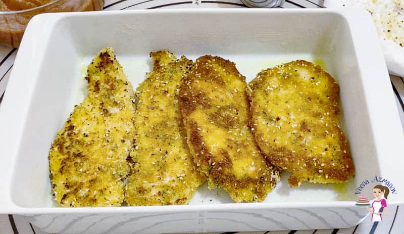 Layer the chicken breast in a baking dish to top with parmesan