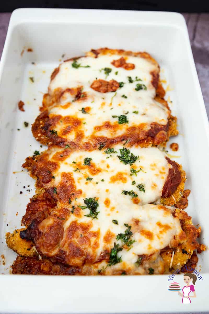 Pieces of chicken Parmesan in a serving dish.