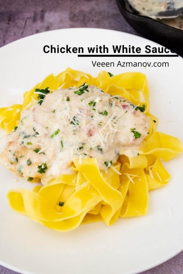 A plate of pasta with chicken in a white sauce.