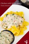 A plate of pasta with chicken in a white sauce.