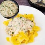 A plate with chicken breast and pasta.
