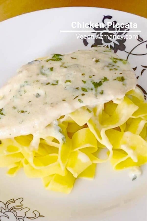A plate of chicken piccata and pasta.