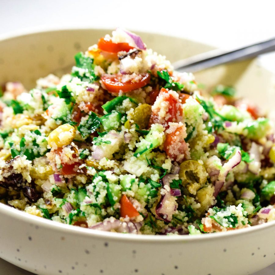 A beige bowl with salad.