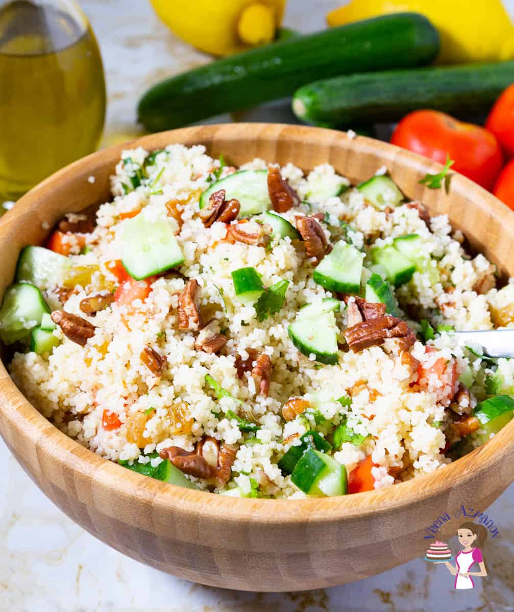 A wooden bowl with couscous salad.