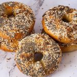 A stack on bagels on the table.
