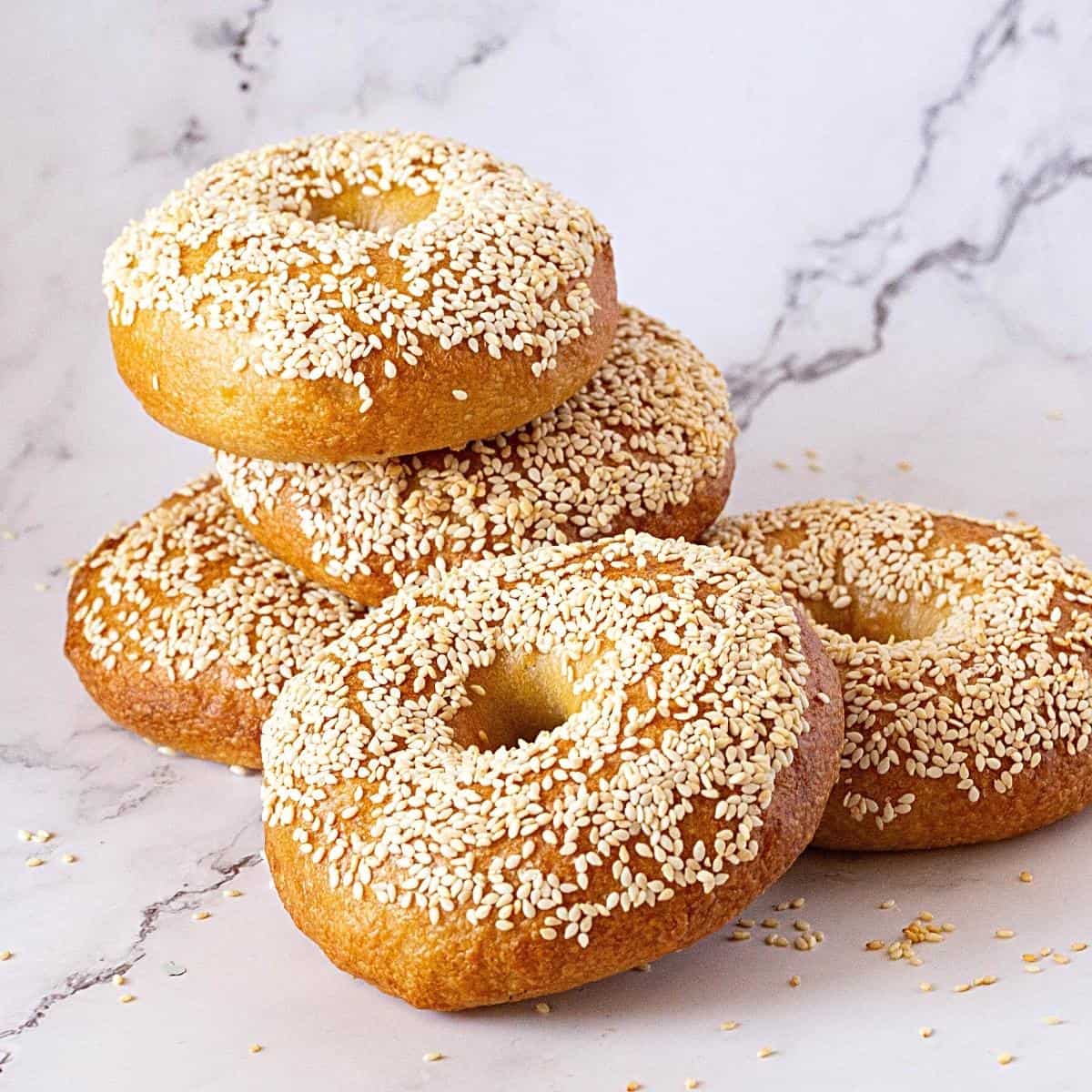 Stack of sesame topped bagels.
