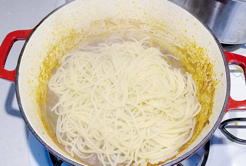A pot of spaghetti being cooked.