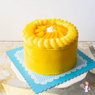 Mango cake on a cake stand.