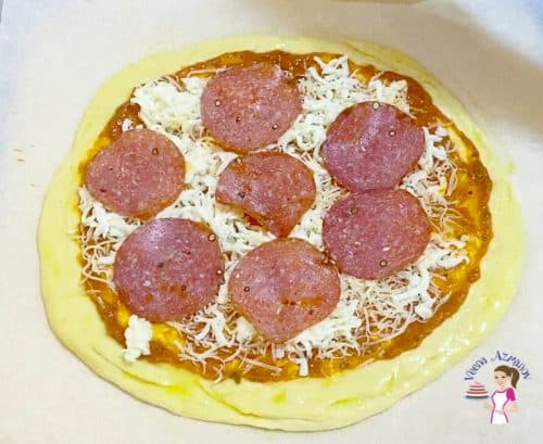 Top the pizza crust with cheese and pepperoni