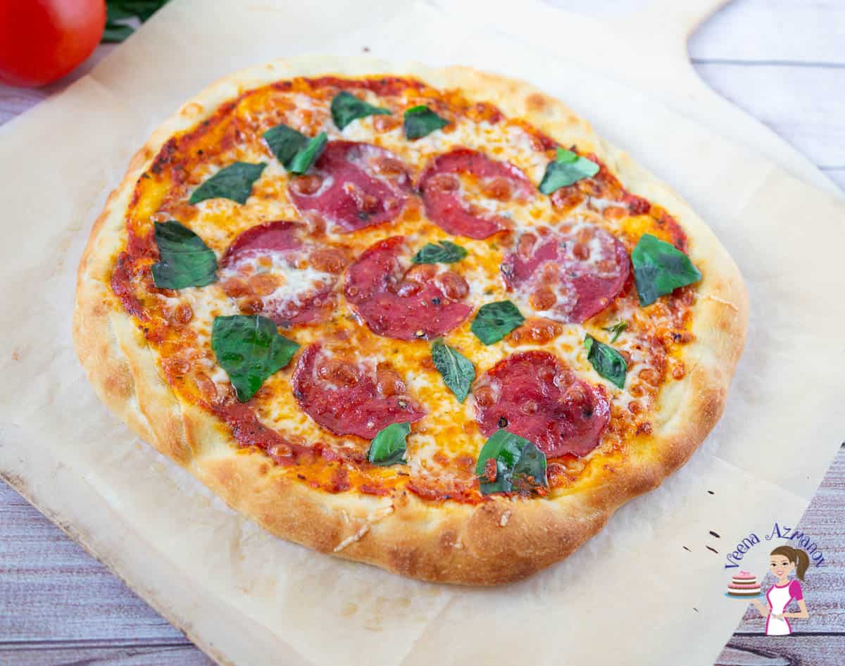 Pepperoni pizza on a wooden tray.