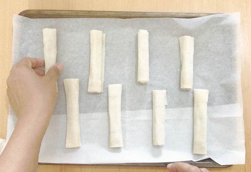 Place the rolled filo cigars on to a baking tray