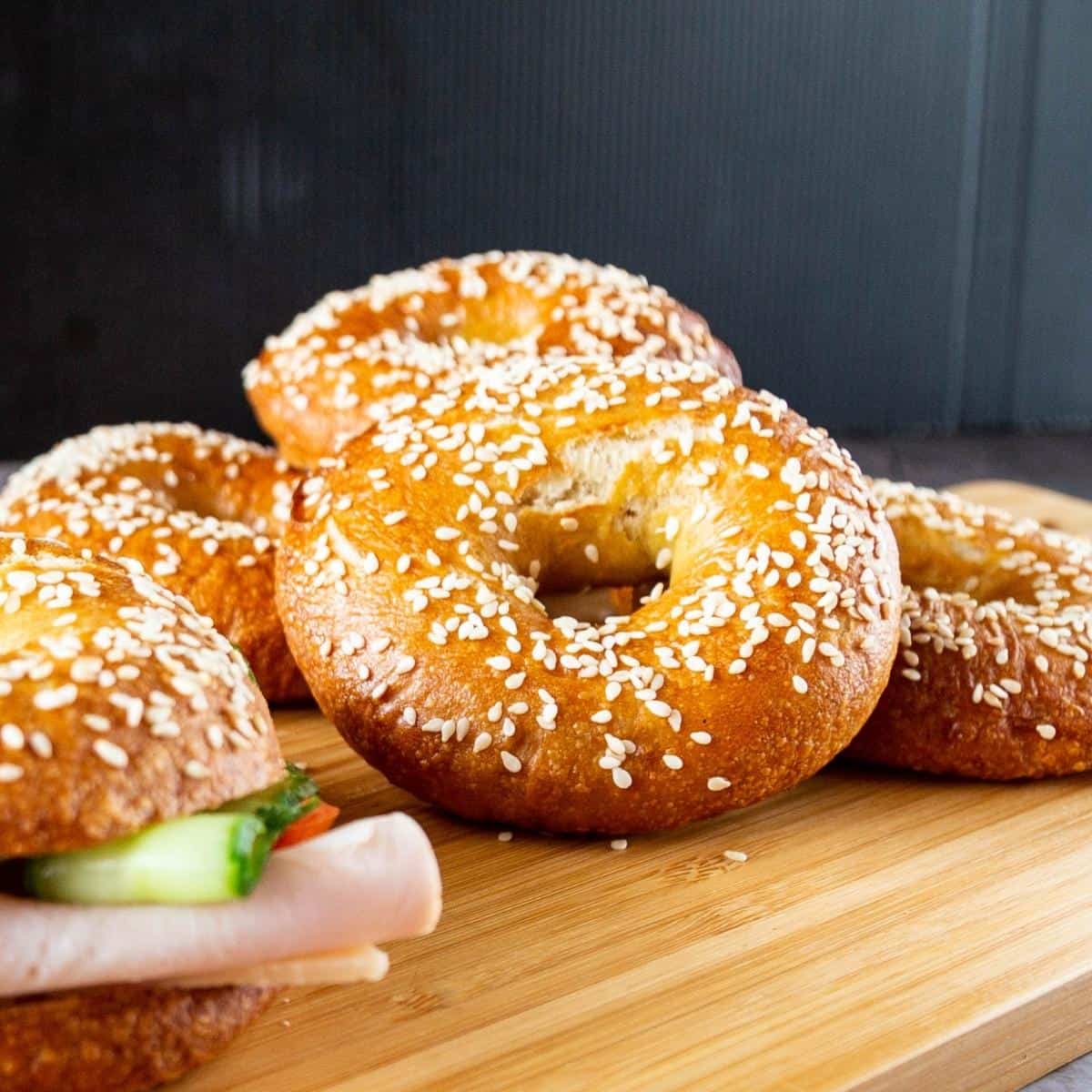 Sesame bagels on a table.