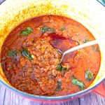 A dutch oven with bolognese sauce.