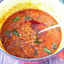 A dutch oven with bolognese sauce.