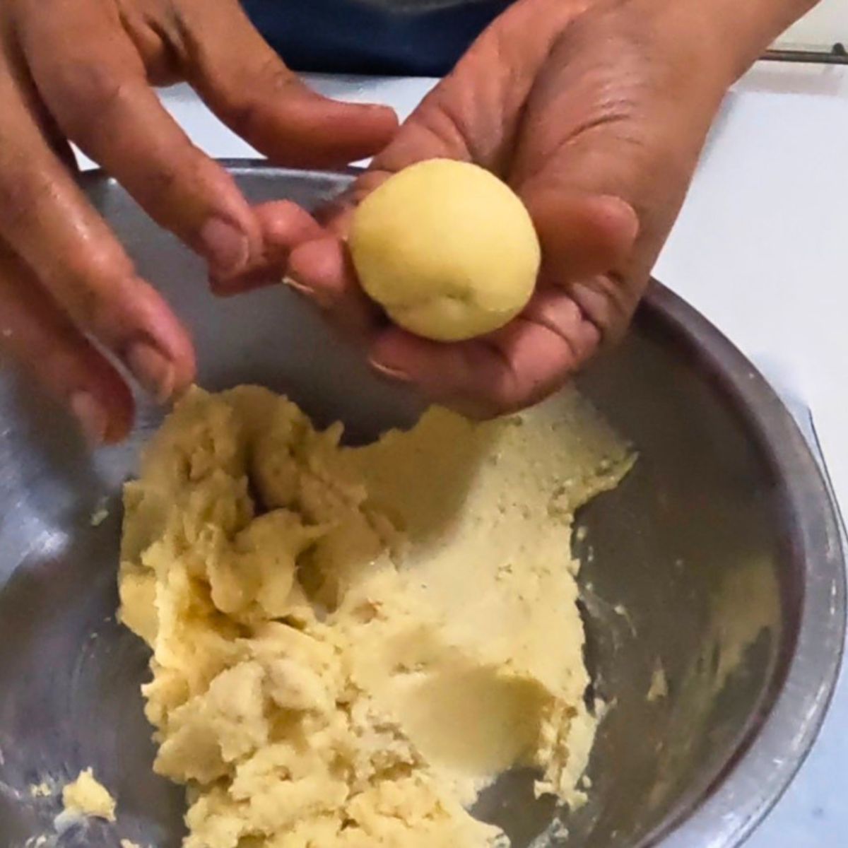 Shaping the cookie dough balls.