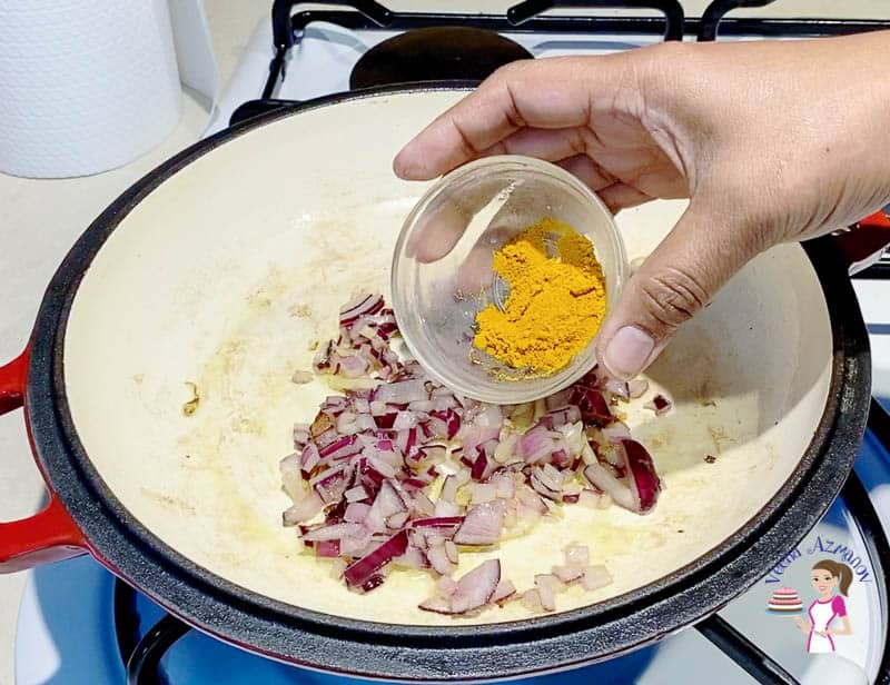 Add turmeric to the onions for the cabbage