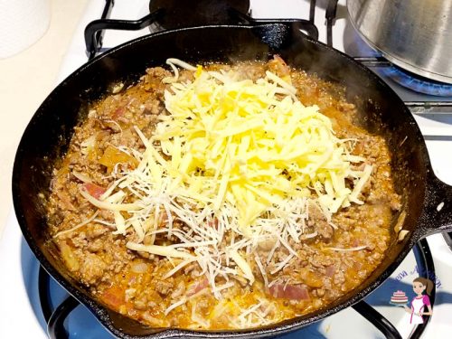 Add the cheese to the enchilada with ground beef
