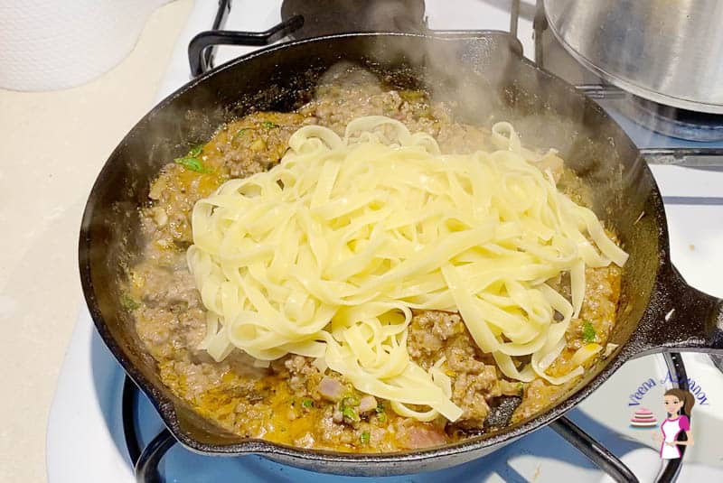 Add the boiled pasta noodles to the ground beef sauce