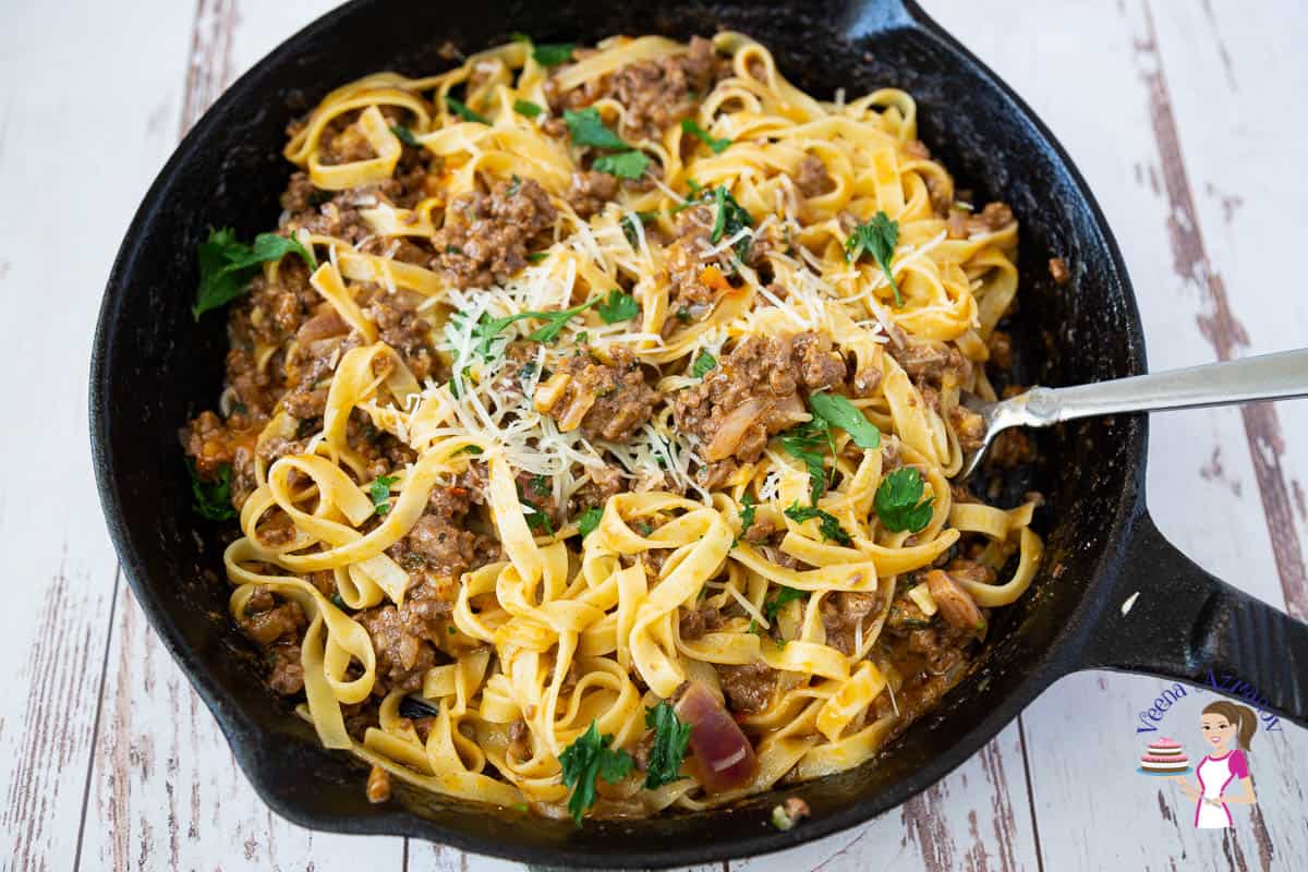 A skillet of pasta with ground beef.