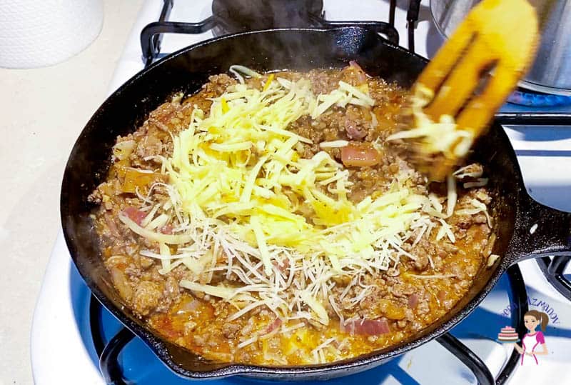 Add the cheese to the beef with enchilada sauce