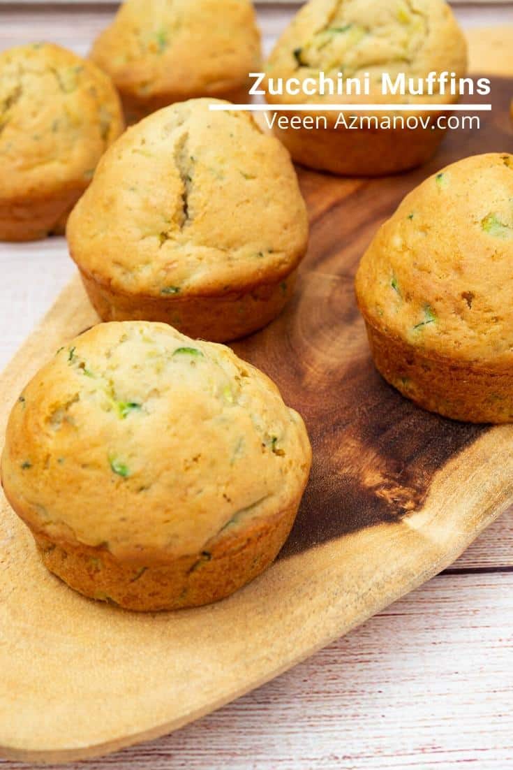Zucchini muffins on a wooden tray.