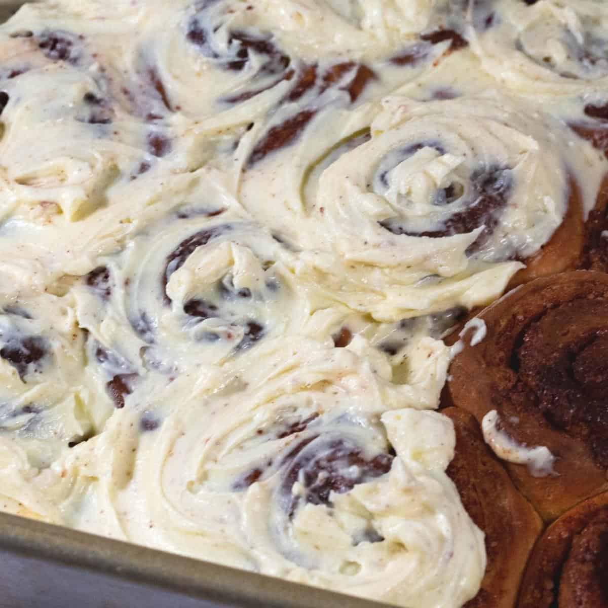 Frosted rolls in a baking dish.