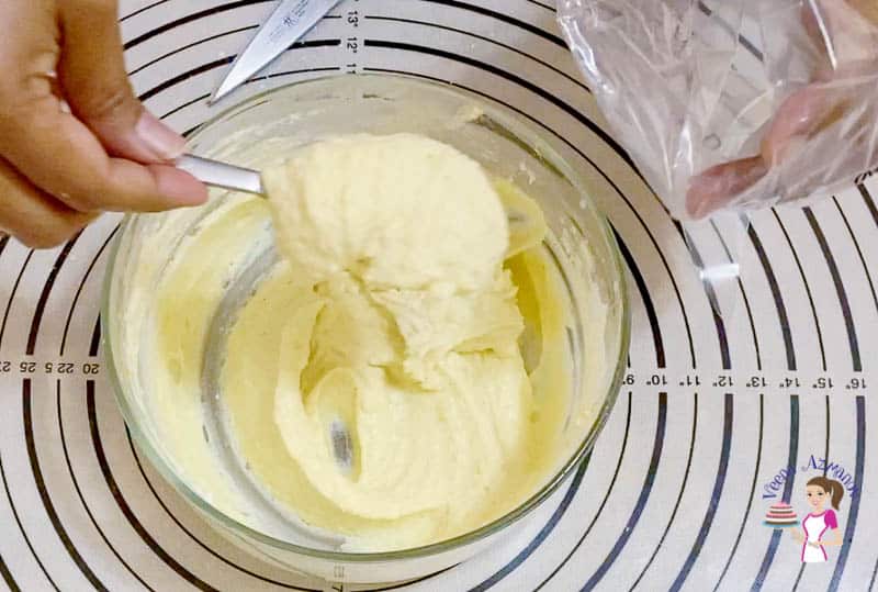 Mixing cream cheese ingredients in a glass bowl.